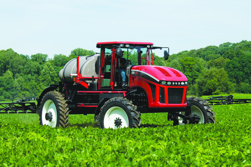 older apache sprayer being used in a bean field